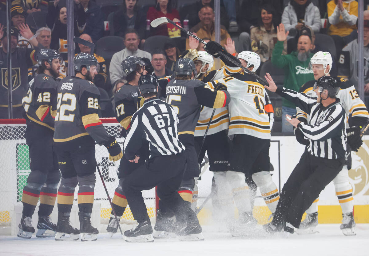 Golden Knights players get into an altercation with the Boston Bruins during the first period o ...