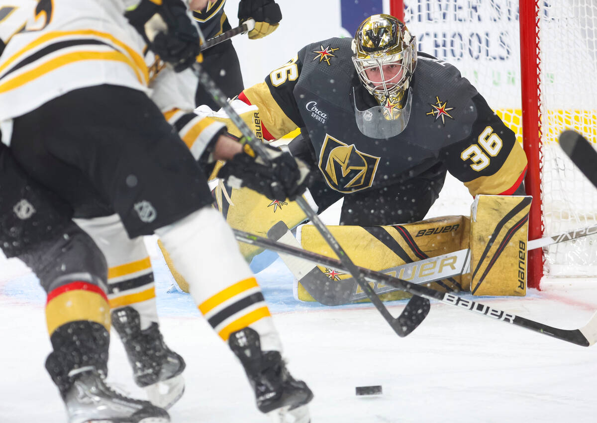 Golden Knights goaltender Logan Thompson (36) eyes the puck during the second period of an NHL ...