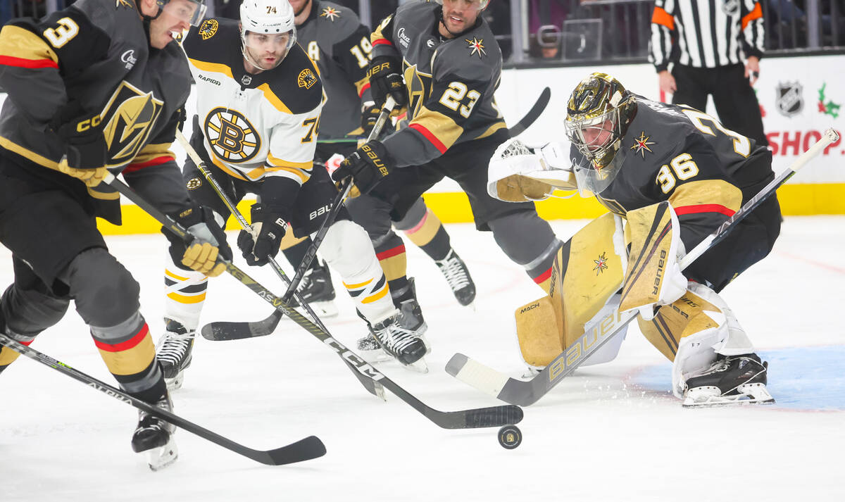 Golden Knights goaltender Logan Thompson (36) defends the net while defenseman Brayden McNabb ( ...