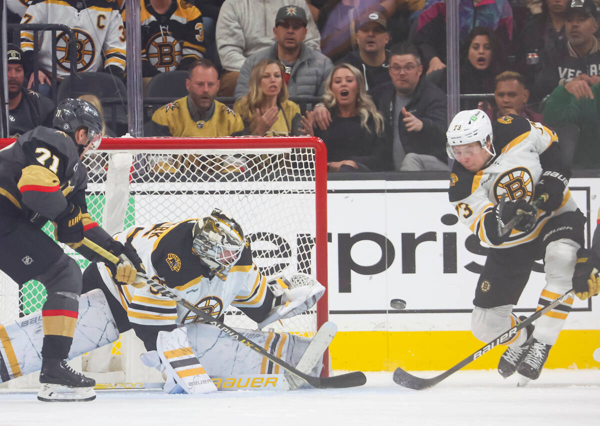 Boston Bruins goaltender Linus Ullmark (35) blocks the puck as Boston Bruins defenseman Charlie ...