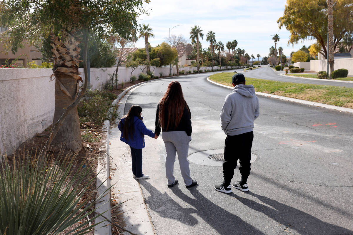 Isaac Garcia, his wife Rosario and their daughter Marissa, 6, look at the scene of a deadly cra ...