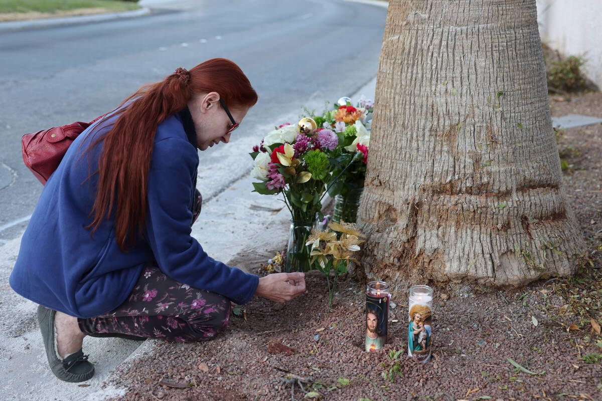 Neighbor Moniqua Childress prays at the site of a deadly crash in the 5000 block of North Scott ...