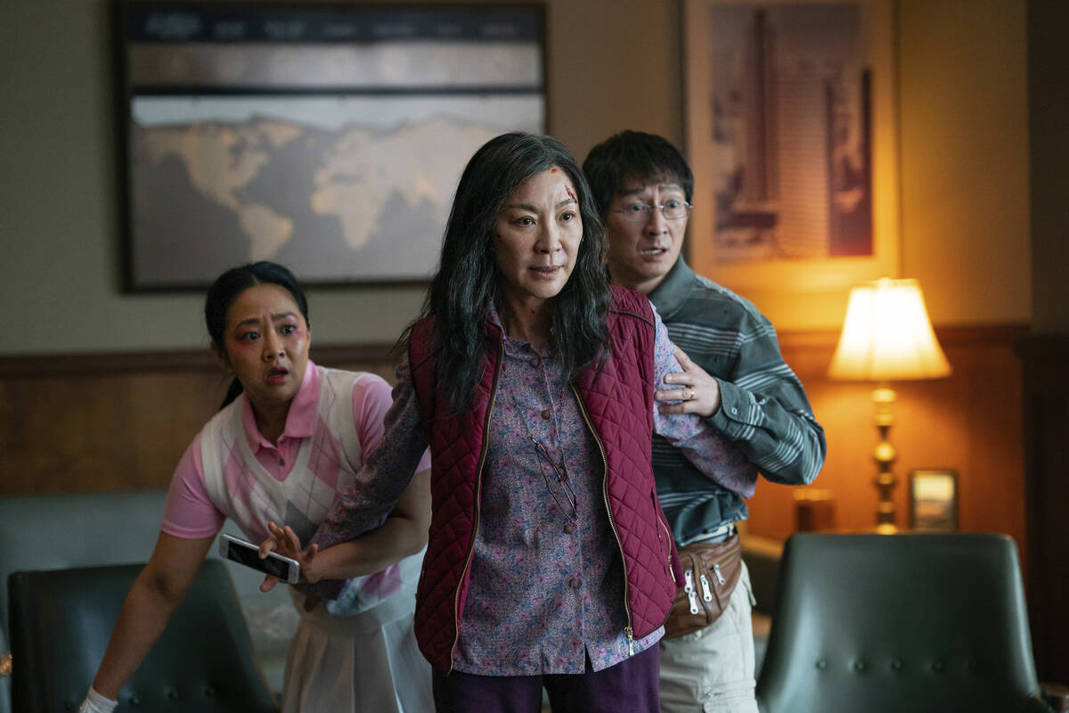 This image released by A24 Films shows, from left, Stephanie Hsu, Michelle Yeoh and Ke Huy Quan ...