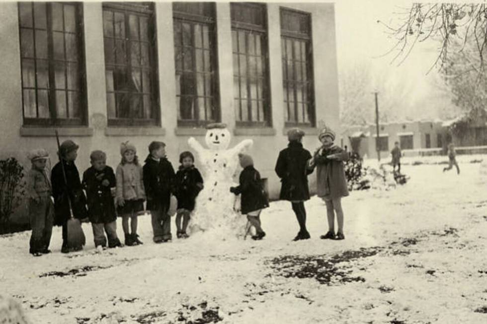 Schoolchildren build a snowman outside of the Fifth Street School in Las Vegas on Jan. 10, 1930 ...