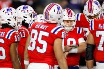 New England Patriots quarterback Mac Jones (10) in the huddle during the second half of an NFL ...
