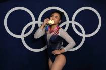 Sunisa Lee, of the USA, poses for a picture after winning the gold medal in the artistic gymnas ...