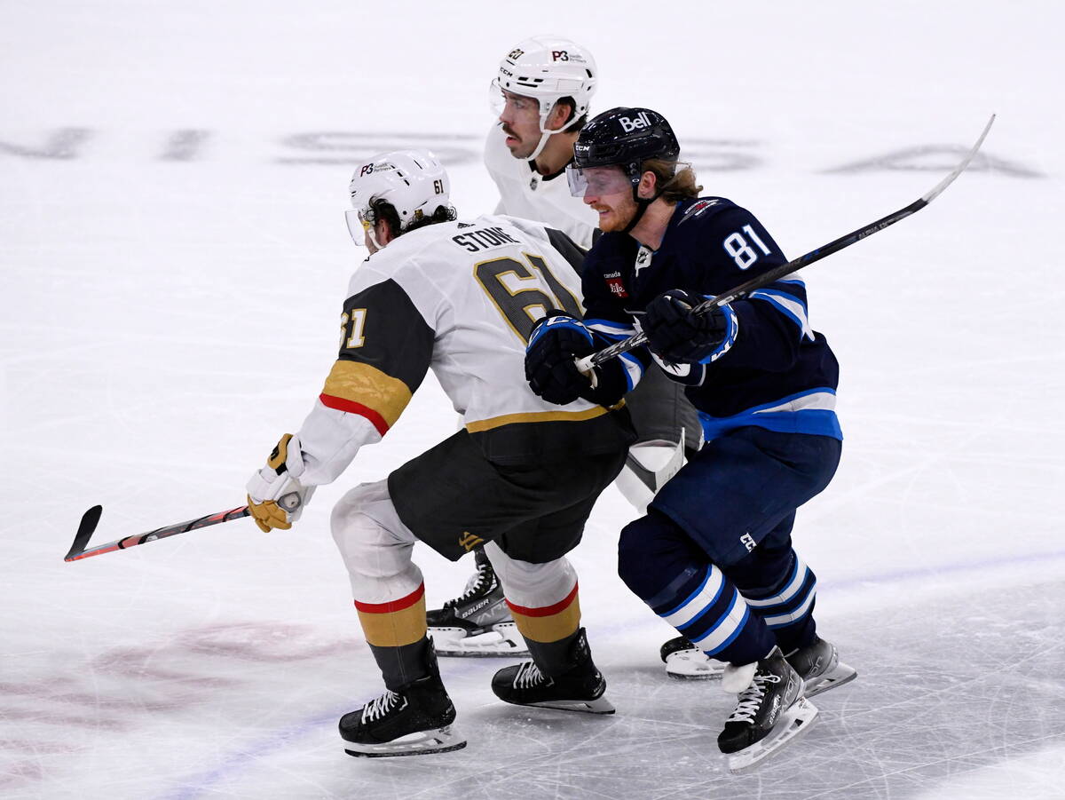 Winnipeg Jets' Kyle Connor (81) states past Vegas Golden Knights' Mark Stone (61) and Chandler ...