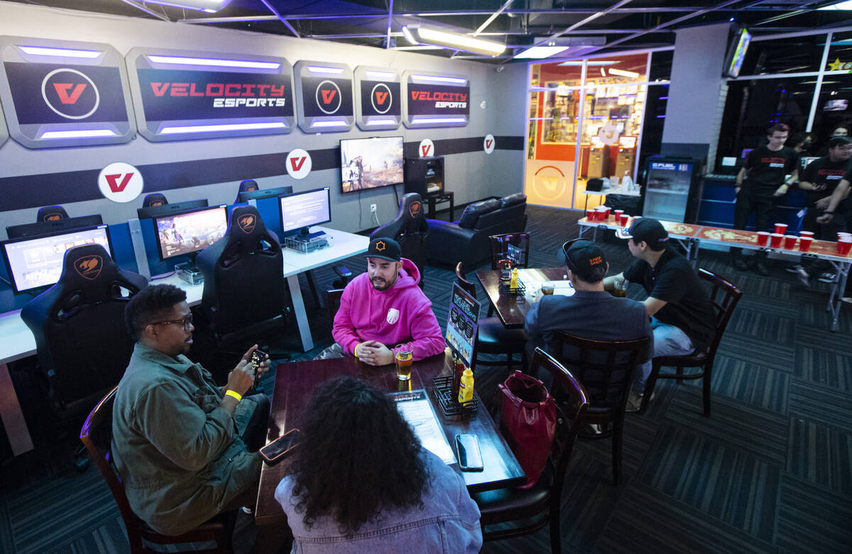 Jairo Urcuyo, CEO of esports team Las Vegas Inferno, in pink, talks with others during a party ...