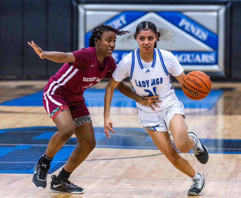 Desert Oasis guard La'Niah Hicks (1) keeps a tight defense on Desert Pines guard Destiny Sao Ma ...