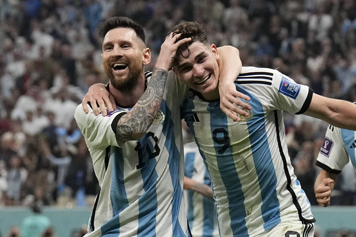 Argentina's Lionel Messi, left, and Argentina's Julian Alvarez celebrate after scoring during t ...