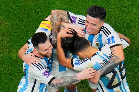 Argentina players celebrate with Argentina's Lionel Messi, left, who scored his side's first go ...