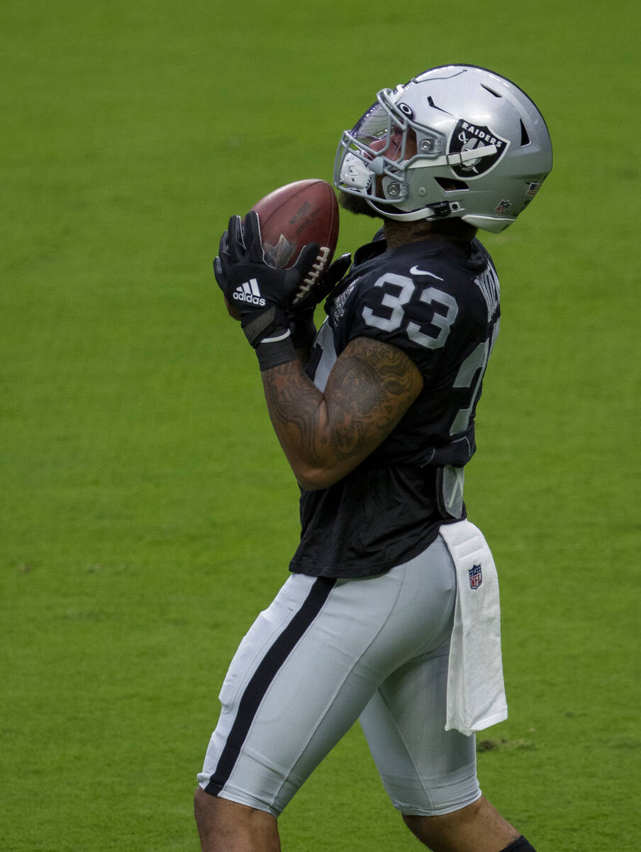 Las Vegas Raiders running back Lynn Bowden Jr. (33) secures a pass while warming up during a fo ...