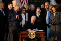 President Joe Biden signs the Respect for Marriage Act, Tuesday, Dec. 13, 2022, on the South La ...