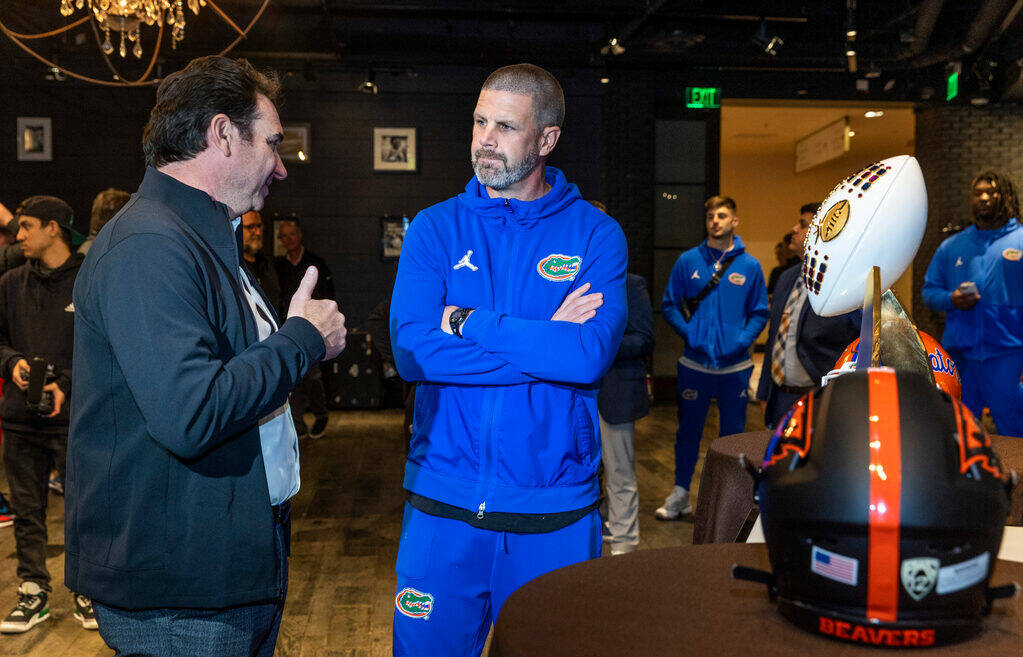 (LtoR) Oregon State Beavers Head Coach Jonathan Smith talks with Florida Gators Head Coach Bill ...