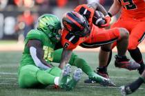 Oregon State running back Damien Martinez (6) is brought down by Oregon defensive back Jamal Hi ...