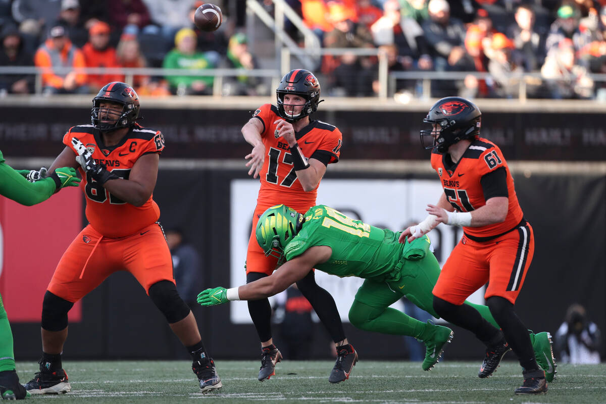 Oregon State quarterback Ben Gulbranson (17) passes under pressure from Oregon linebacker Mase ...