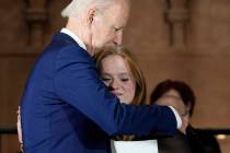 President Joe Biden hugs Sandy Hook survivor Jackie Hegarty, who introduced him, during an even ...