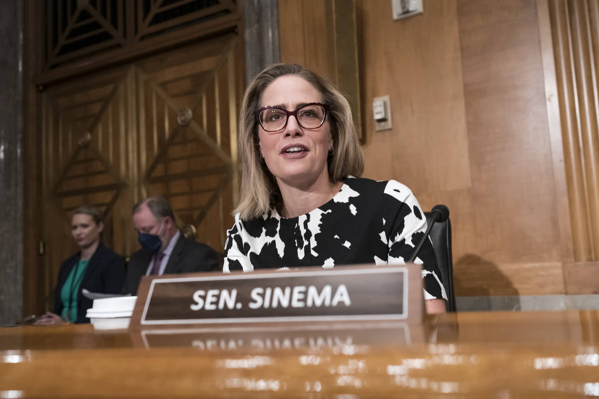FILE -Sen. Kyrsten Sinema, D-Ariz., arrives for a meeting of the Senate Homeland Security Commi ...