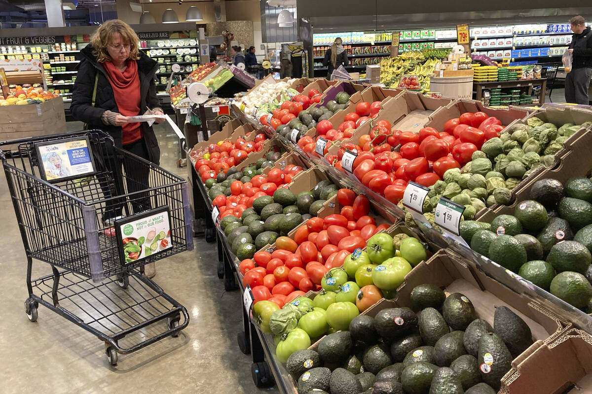 FILE - Shoppers pick out items at a grocery store in Glenview, Ill., Saturday, Nov. 19, 2022. T ...