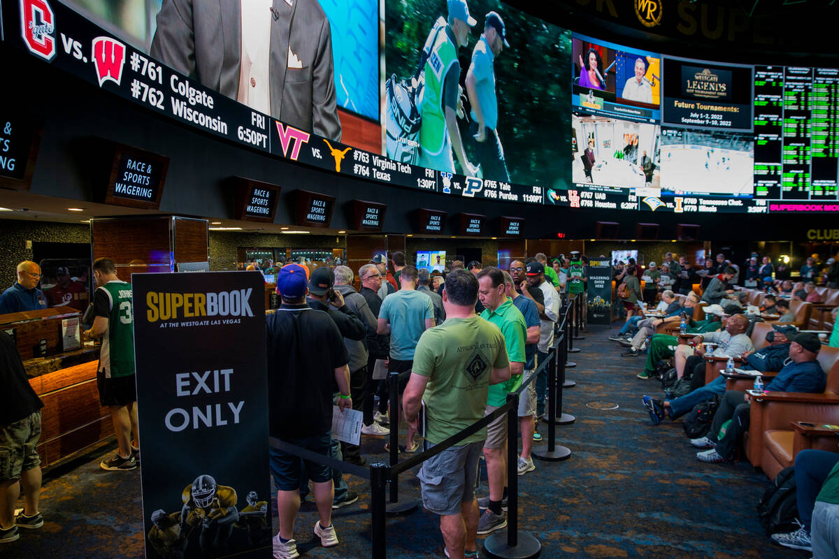 Bettors stand in line to put their money down as March Madness begins in the SuperBook at Westg ...