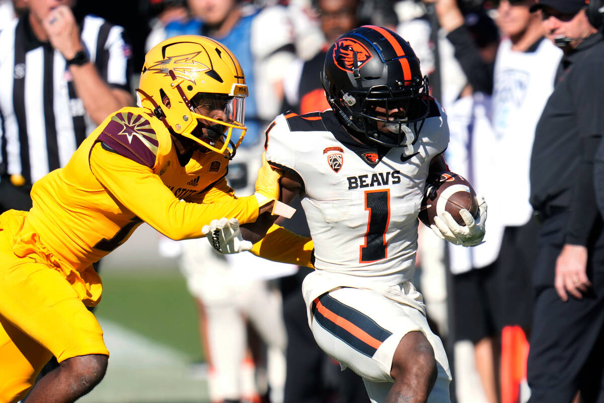 Oregon State wide receiver Tyjon Lindsey (1) is forced out of bounds by Arizona State defensive ...