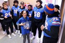 Opportunity Village Ambassador Vanessa Stegall gives members of the University of Florida footb ...