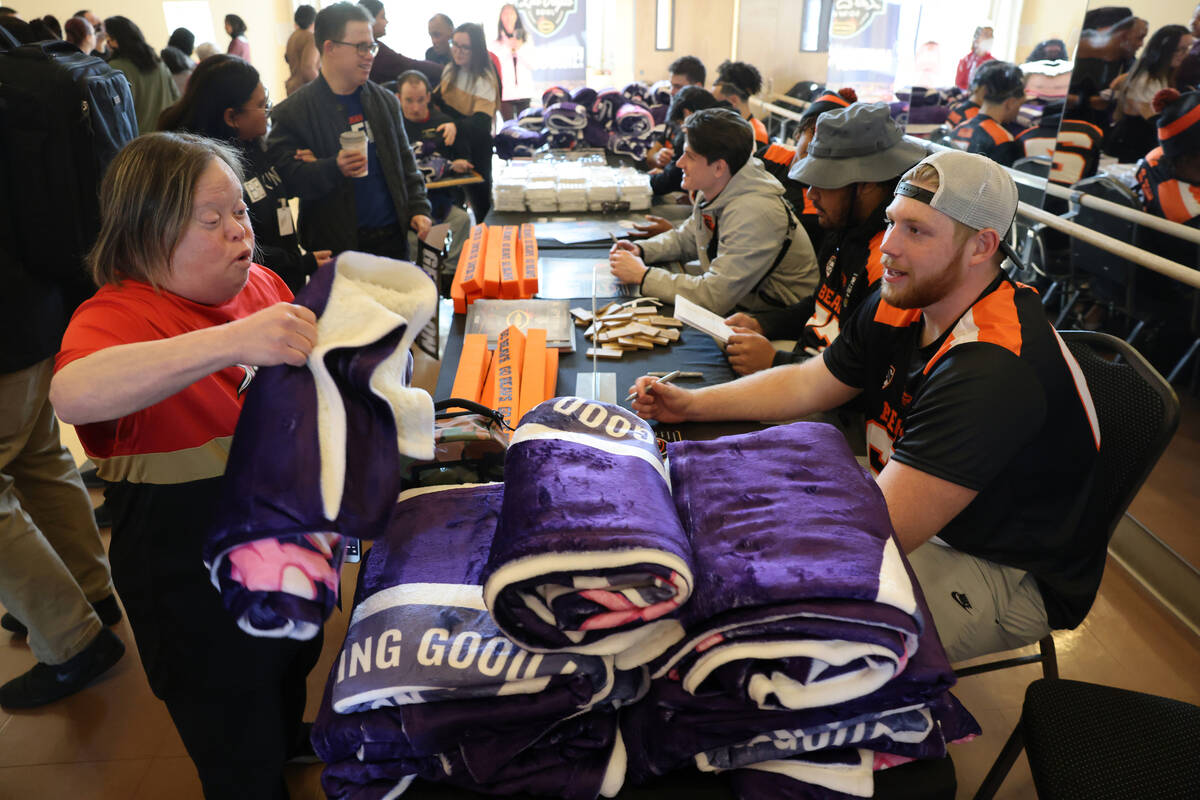 Opportunity Village program participant Sharen Golbois gets swag from Oregon State offensive li ...