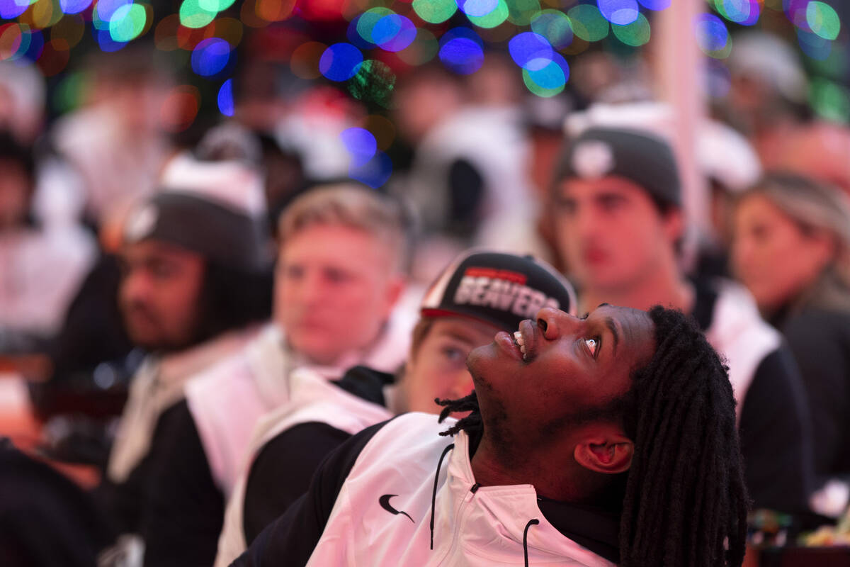 An Oregon State player watches game highlights on the ceiling during a welcome reception ahead ...