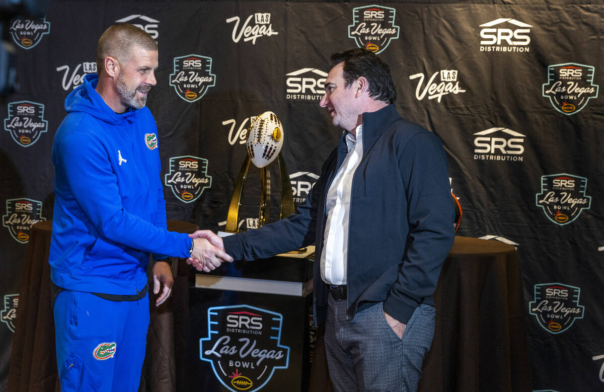 (LtoR) Florida Gators Head Coach Billy Napier shakes hands with Oregon State Beavers Head Coach ...