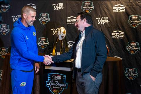 (LtoR) Florida Gators Head Coach Billy Napier shakes hands with Oregon State Beavers Head Coach ...