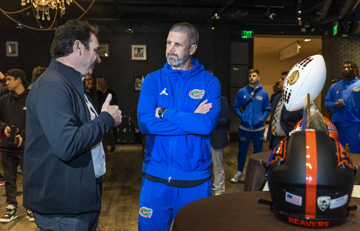 (LtoR) Oregon State Beavers Head Coach Jonathan Smith talks with Florida Gators Head Coach Bill ...