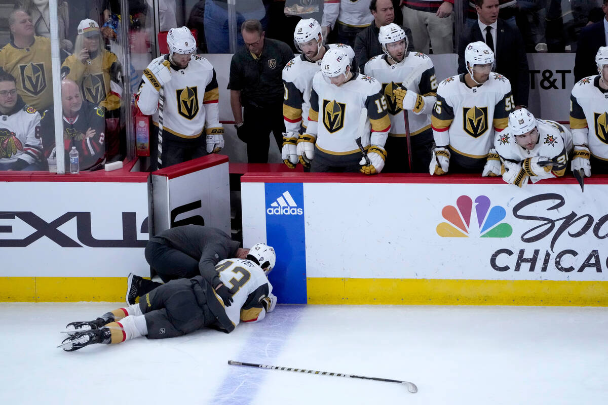 Vegas Golden Knights' Paul Cotter is attended to on the ice after getting checked by Chicago Bl ...
