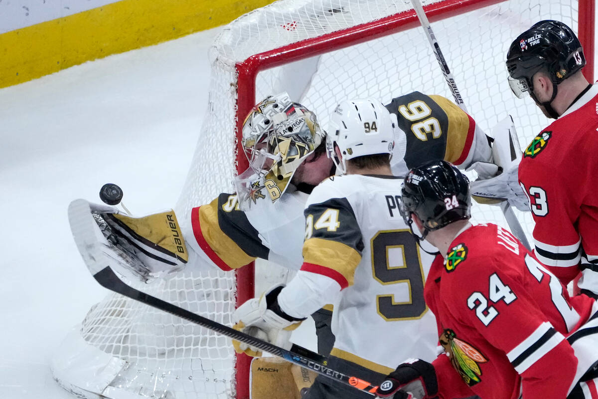 Vegas Golden Knights goaltender Logan Thompson (36) knocks the puck away from the goal with is ...