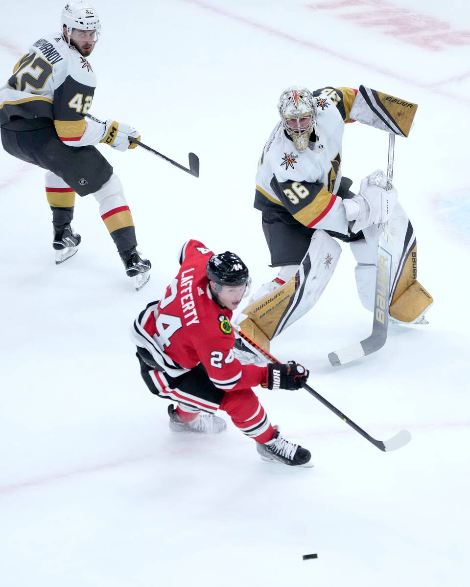 Vegas Golden Knights goaltender Logan Thompson (36) clears the loose puck away from Chicago Bla ...