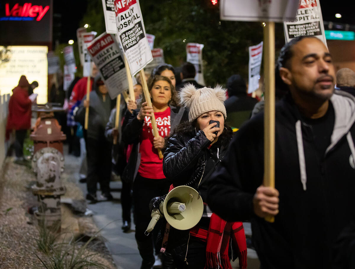 Ericka Lopez leads a chant during the Culinary Union workers picket outside Valley Hospital on ...