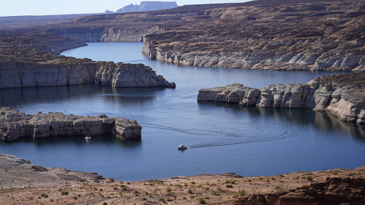 FILE - A boat cruises along Lake Powell near Page, Ariz., on July 31, 2021. (AP Photo/Rick Bowm ...