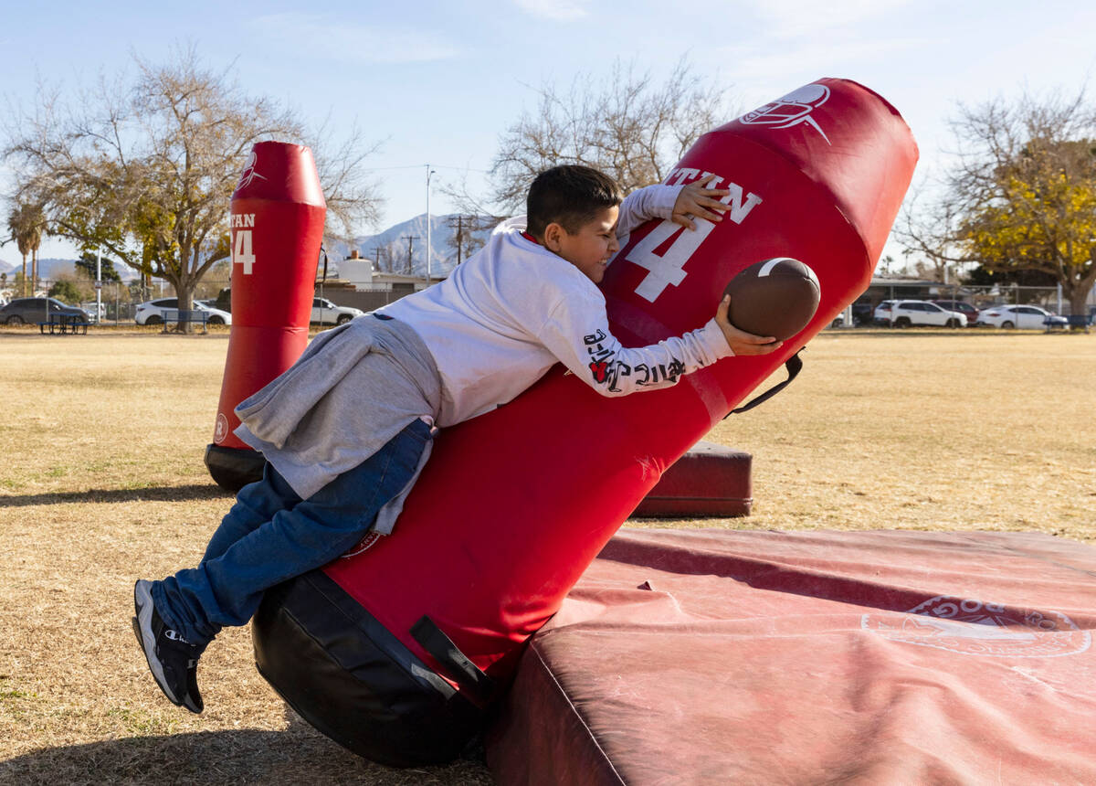 C.P. Squires Elementary School student Esteban Garcia, 9, tackles a dummy during the Goodie Two ...