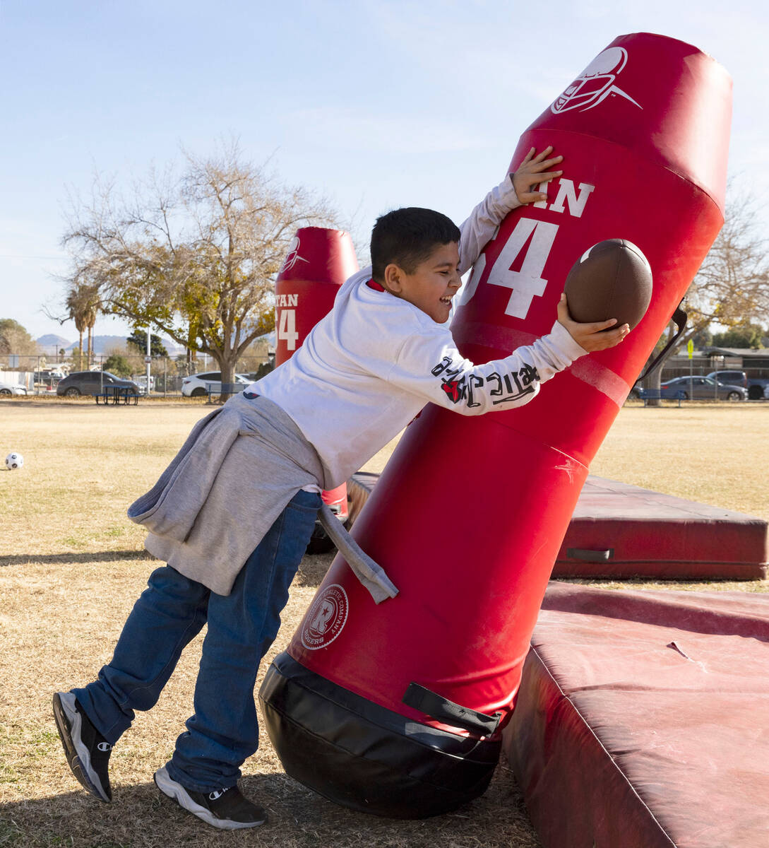 C.P. Squires Elementary School student Esteban Garcia, 9, tackles a dummy during the Goodie Two ...