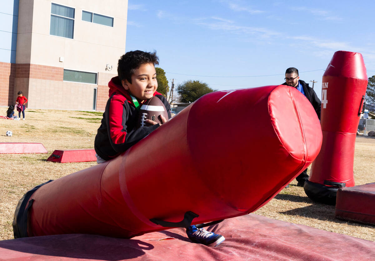 C.P. Squires Elementary School student Rudolf Naranjo, 9, tackles a dummy during the Goodie Two ...