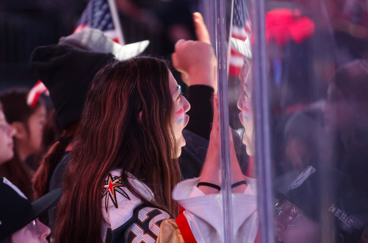 USA hockey fans cheer at the start of the first period of a rivalry hockey game against Canada ...