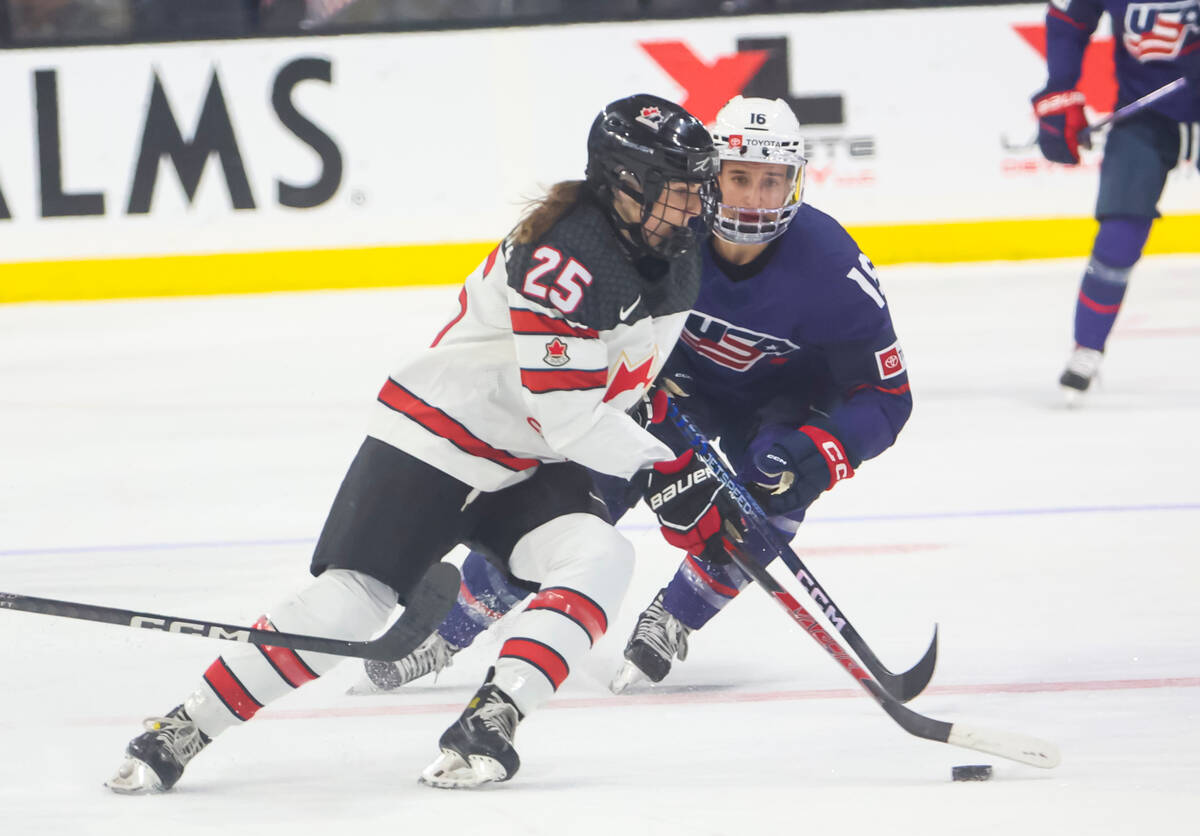 Canada's Jaime Bourbonnais (25) skates with the puck under pressure from United States' Hayley ...