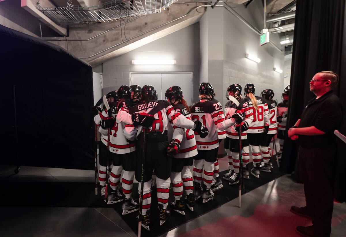 Members of team Canada huddle before a rivalry hockey game against United States at the Dollar ...