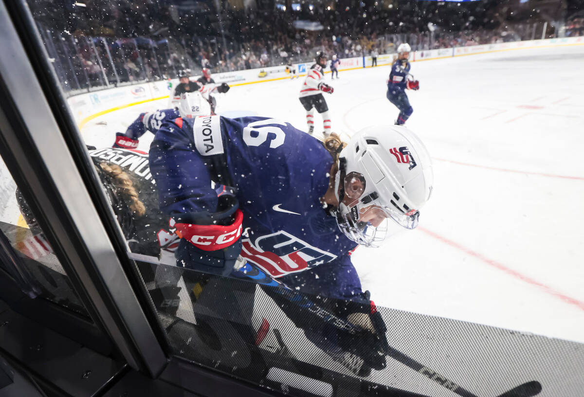 United States' Hayley Scamurra (16) battles for the puck against Canada during the first period ...