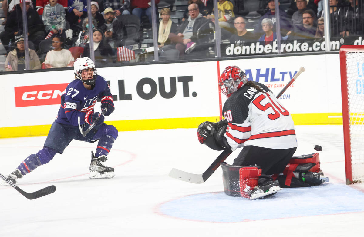 Canada goaltender Kristen Campbell (50) blocks a shot from United States' Taylor Heise (27) dur ...