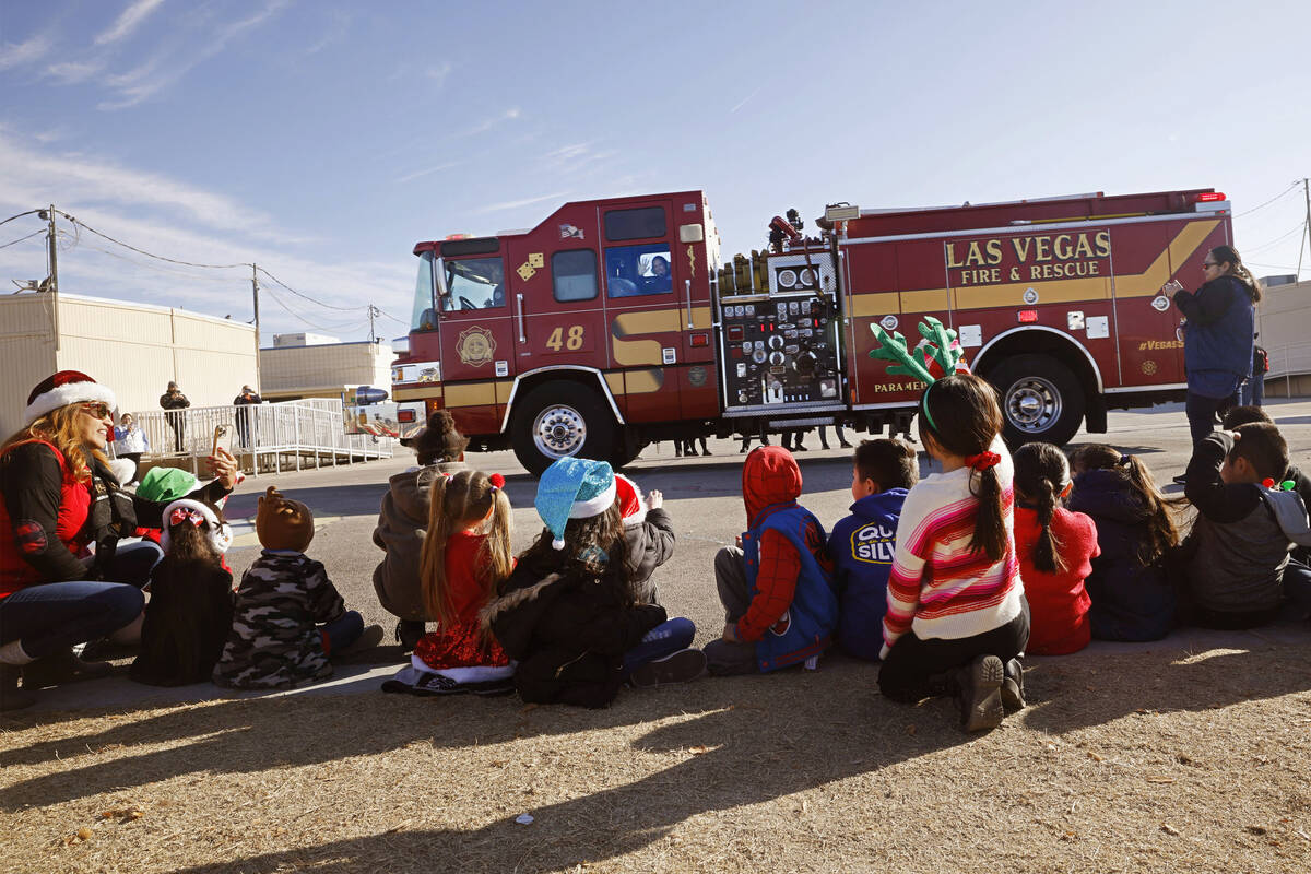 A Las Vegas fire truck arrives at Fay Herron Elementary School to deliver the toys, Thursday, D ...