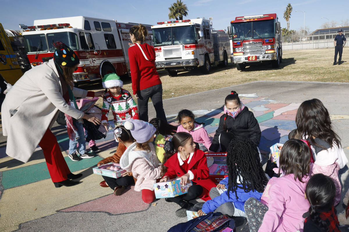 Fay Herron Elementary School students look at toys after they received, Thursday, Dec. 15, 2022 ...
