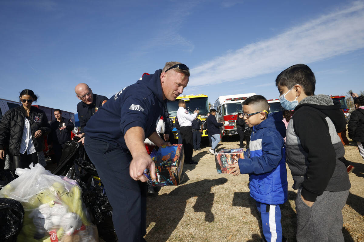 Las Vegas Fire & Rescue Captain Kenny Reinhart, left, speaks to first grader Josue Burgarin ...