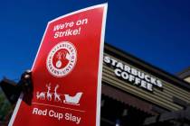 FILE - Starbucks employees strike outside their store in Mesa, Ariz., Nov. 17, 2022. Starbucks ...