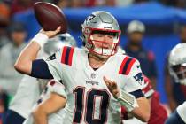 New England Patriots quarterback Mac Jones (10) throws against the Arizona Cardinals during the ...