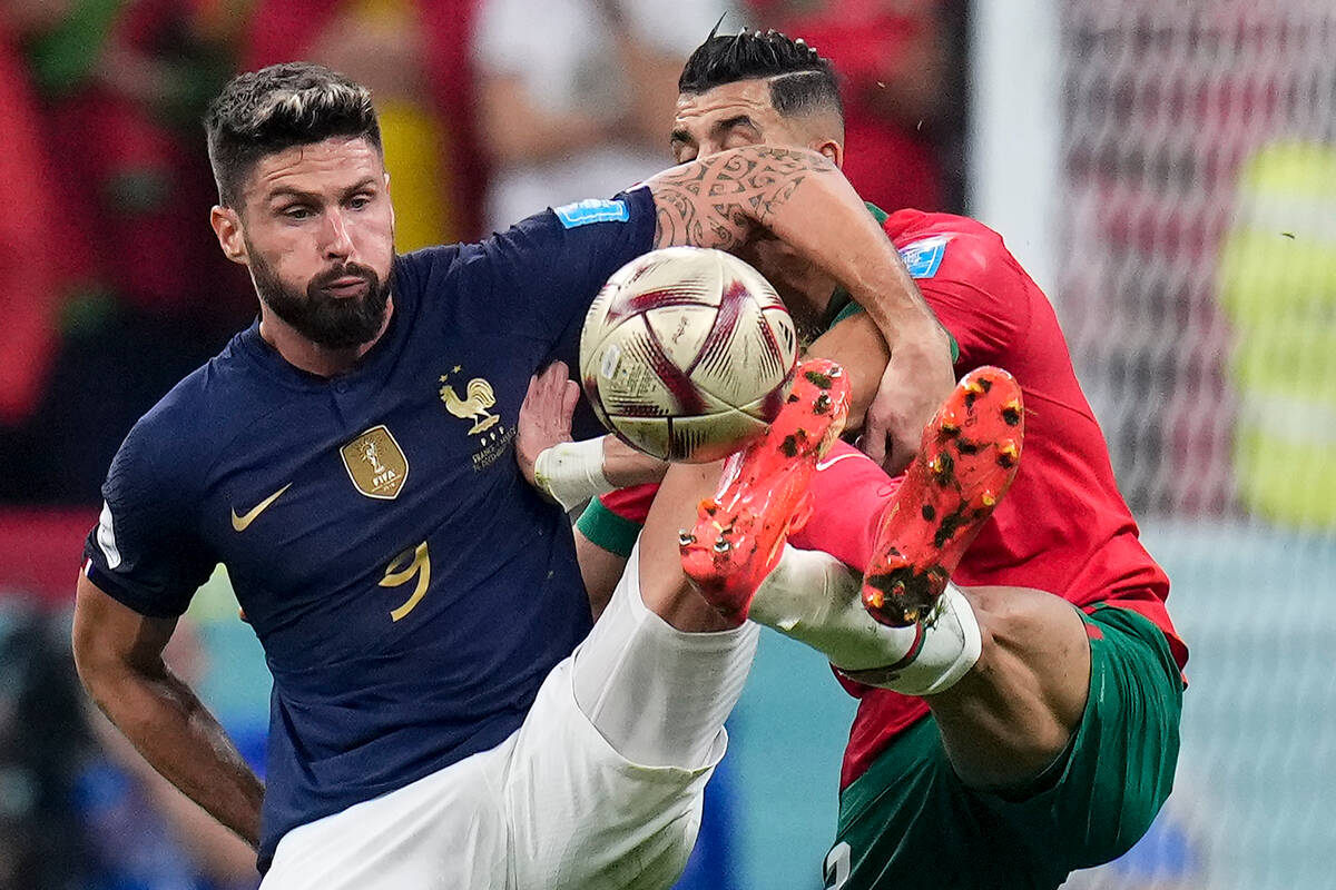 France's Olivier Giroud and Morocco's Noussair Mazraoui, right, vie for the ball during the Wor ...